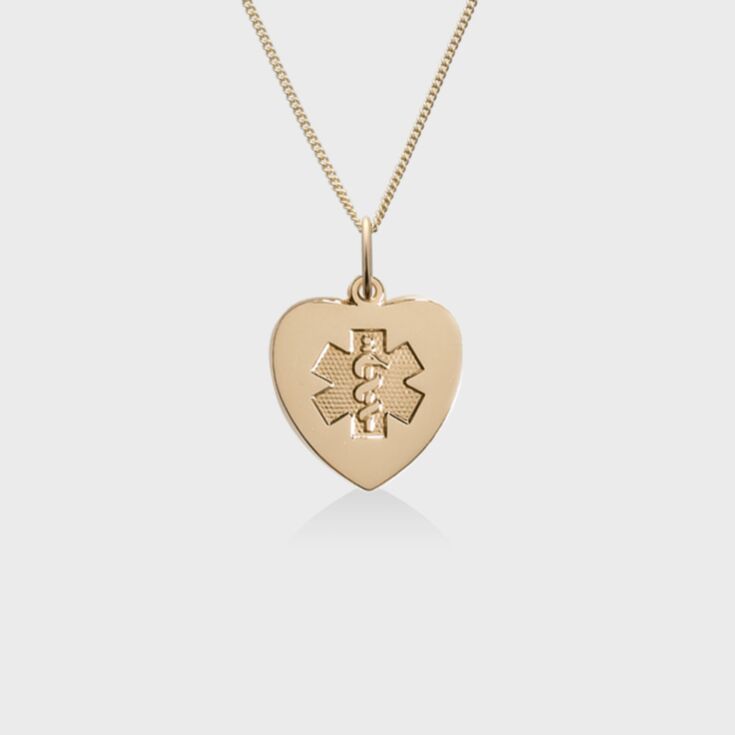 Heart-shaped gold pendant with embossed medical emblem